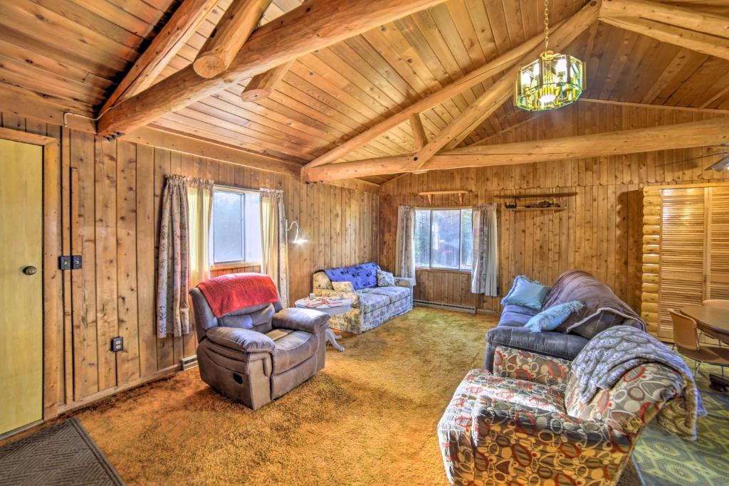 a living room with couches and chairs in a cabin at Cornell Home with Fire Pit and Hunting Access! in Cornell