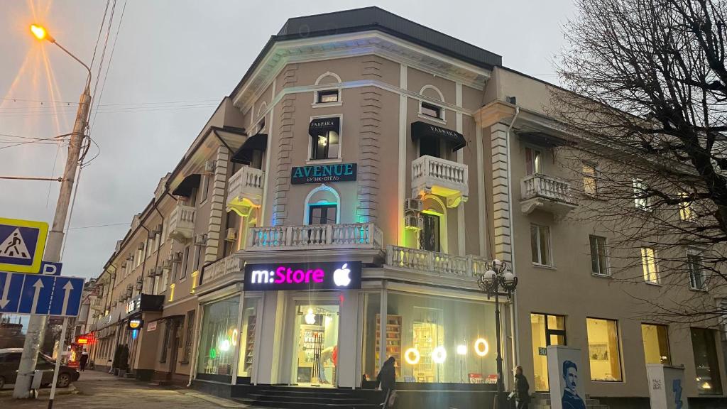 a large building with a store in front of it at Бутик отель AVENUE in Nalchik
