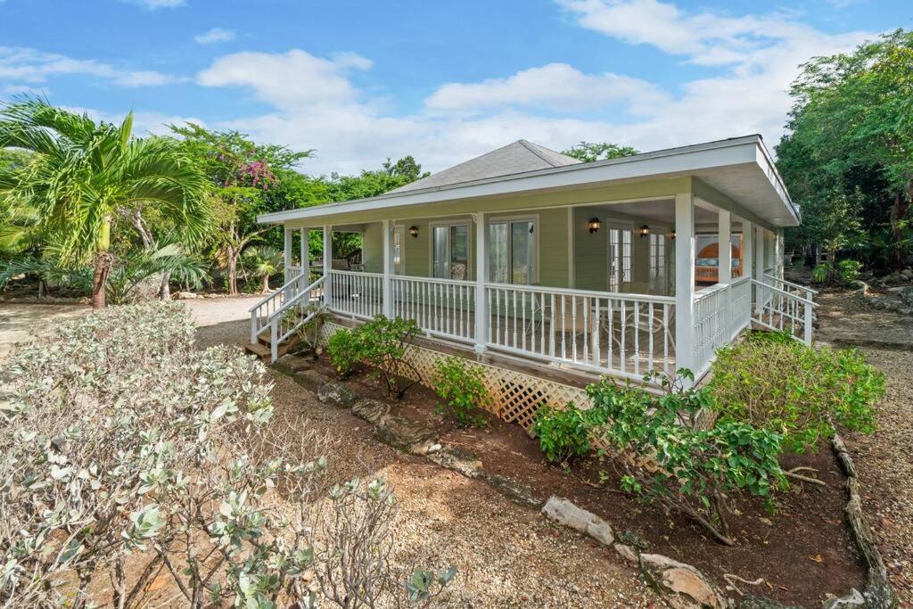 a small house with a white porch and a porch at Peace and Play in Hermitage