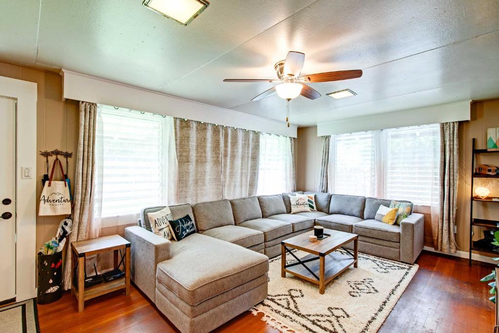 a living room with a couch and a ceiling fan at Hale Leilani - Hilo 3BR cold AC in Hilo