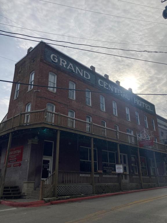 a large red brick building with a sign on it at Grand Central Hotel in Eureka Springs