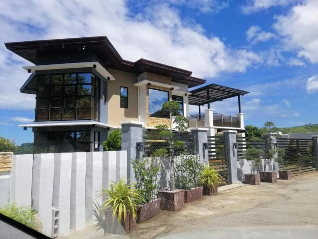 a house with a white fence in front of it at Luxury Villa at Mariveles Bataan Philippines Ph in Mariveles