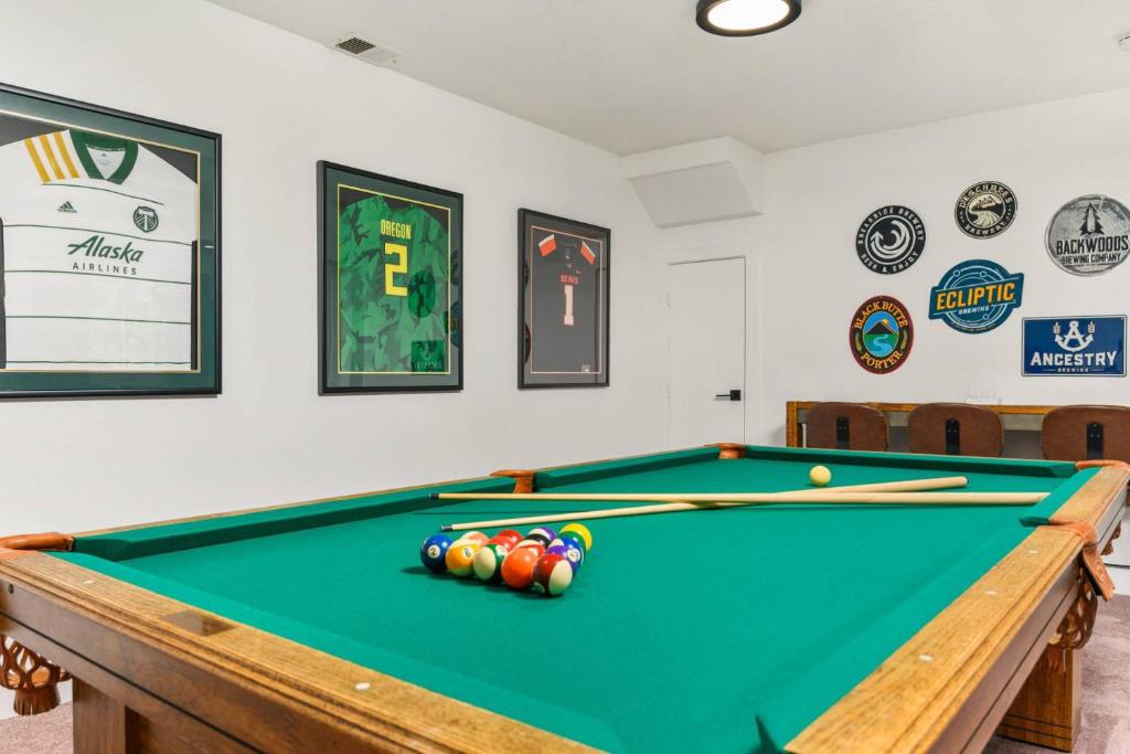 a snooker table in a room with a pool at Tanner Basin Retreat in West Linn