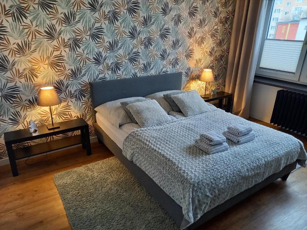 a bedroom with a bed with two night stands and two lamps at Brzeźno plaża in Gdańsk