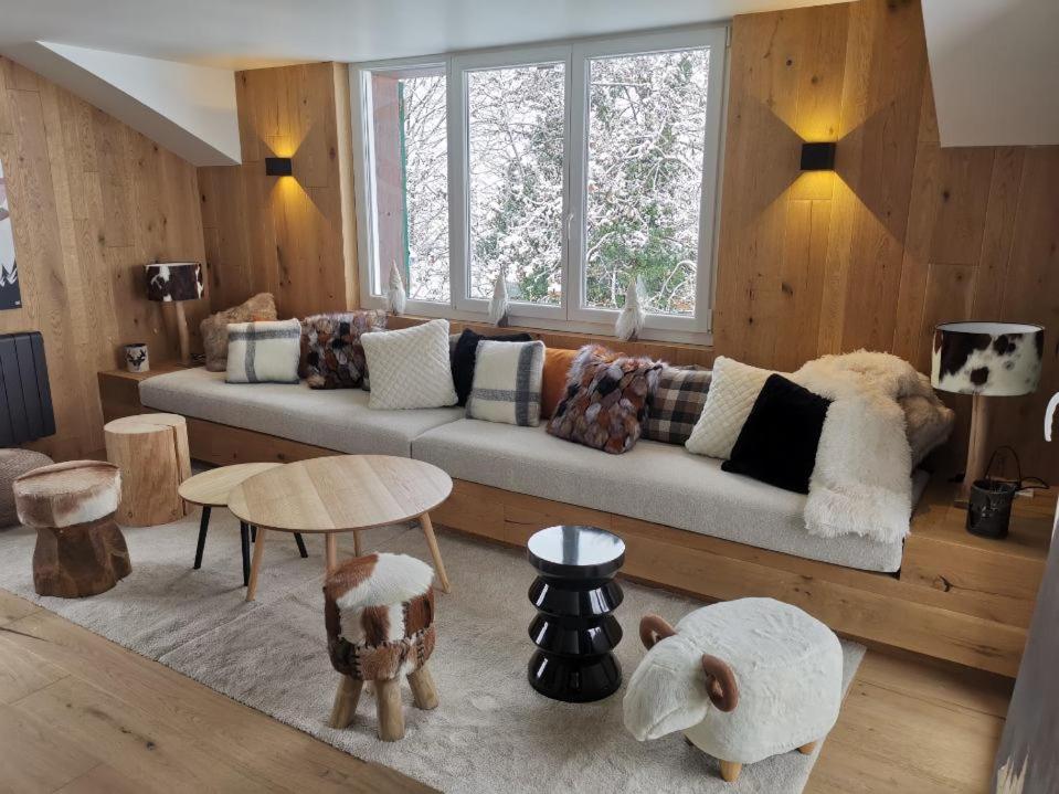 a living room with a couch and a window at Kaban' des neiges in Saint-Gervais-les-Bains