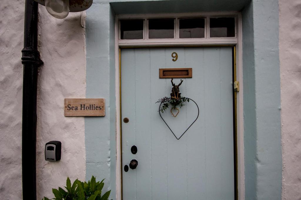 a white door with a heart sign on it at Sea Hollies in Aberdour