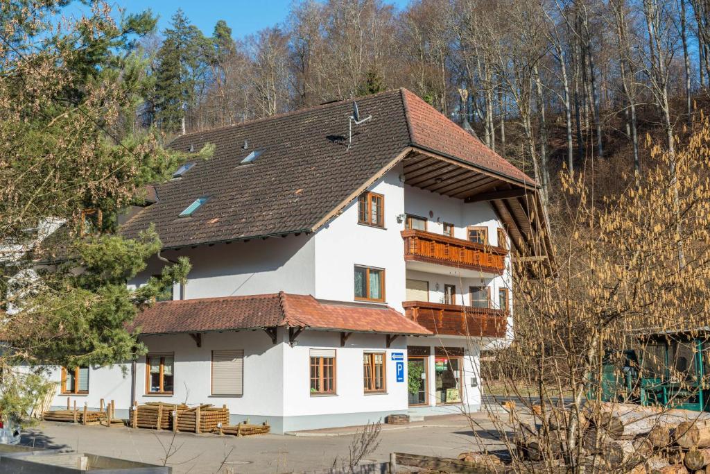 a white house with a brown roof at Ferienwohnung Maria in Liggersdorf