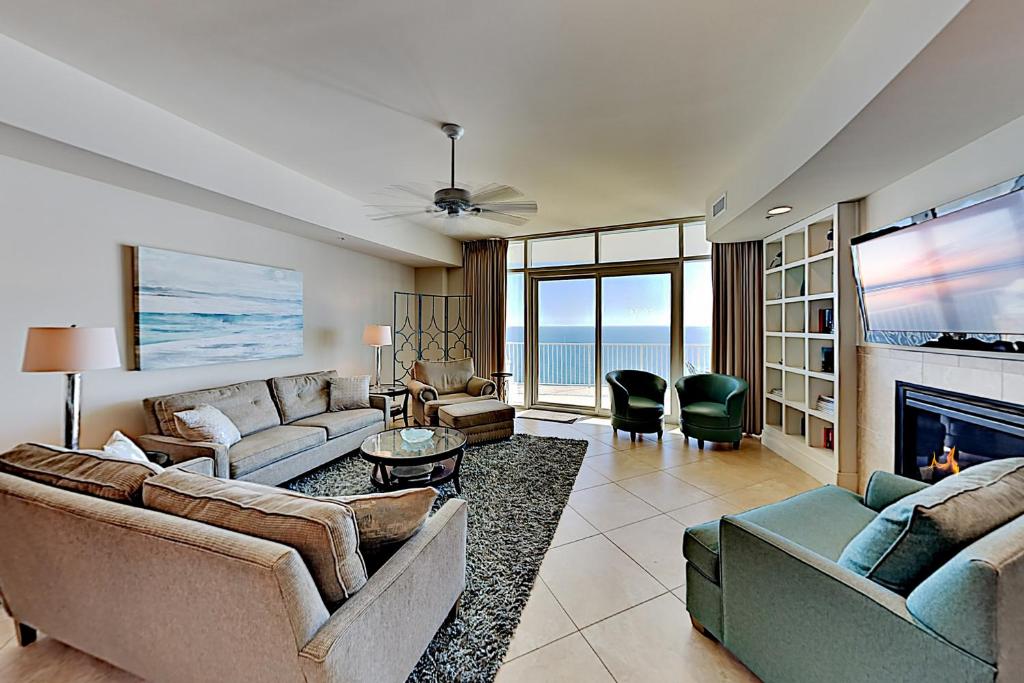 a living room with two couches and a fireplace at Turquoise Place #2205C in Orange Beach