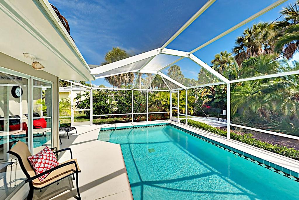 a house with a swimming pool and a patio at Anything Is Possible in Sarasota