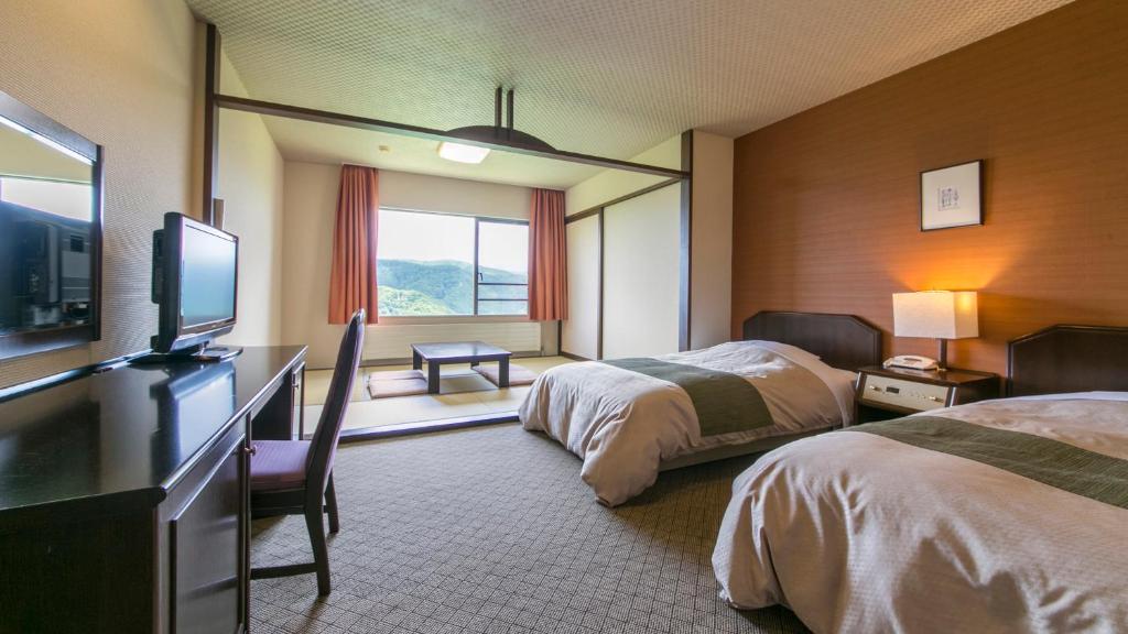 Postel nebo postele na pokoji v ubytování Sky Park Hotel