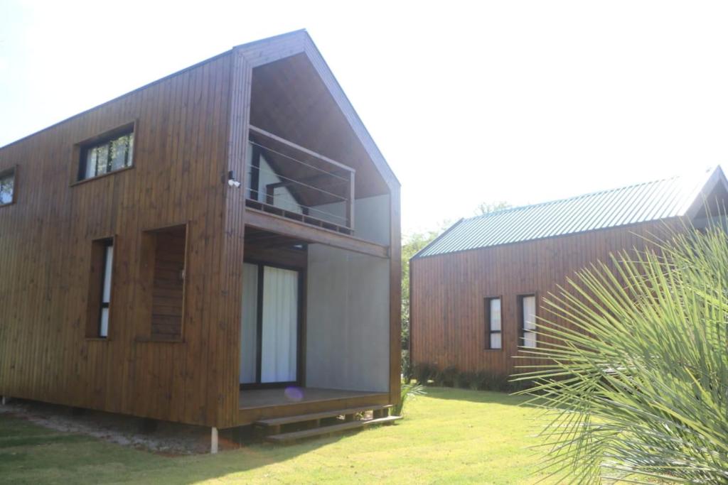 a house with a large window on the side of it at IbiraCottage in Imbituba