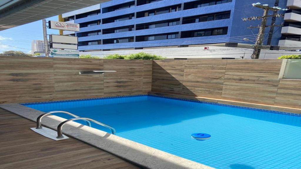 a swimming pool in front of a large building at APARTAMENTO PONTA VERDE - MACEIO-AL in Maceió