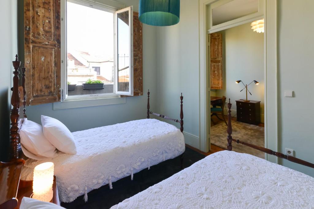 Postel nebo postele na pokoji v ubytování Maison des Amis Porto