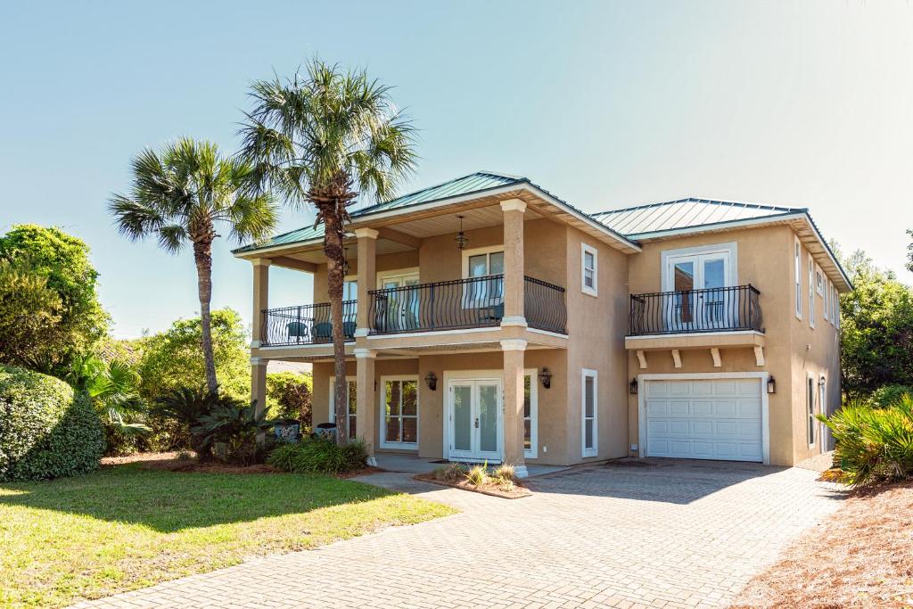 a large house with palm trees and a driveway at Destination Destiny in Destin