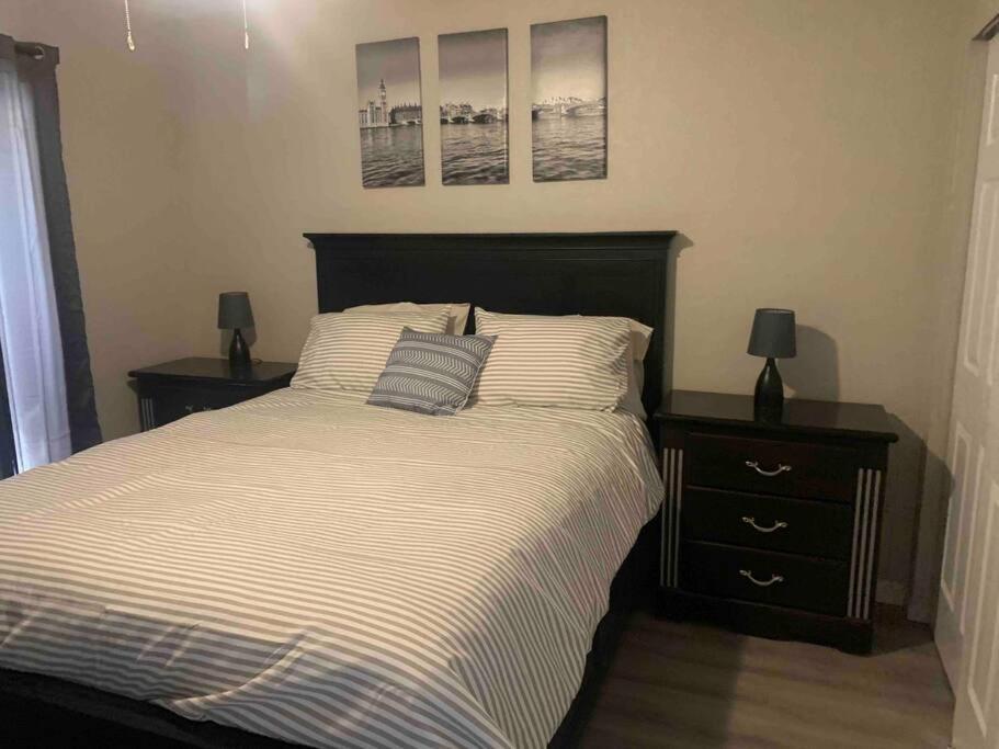 a bedroom with a bed with two night stands and two lamps at Lake Havasu Retreat w pool Everything Nearby! in Lake Havasu City