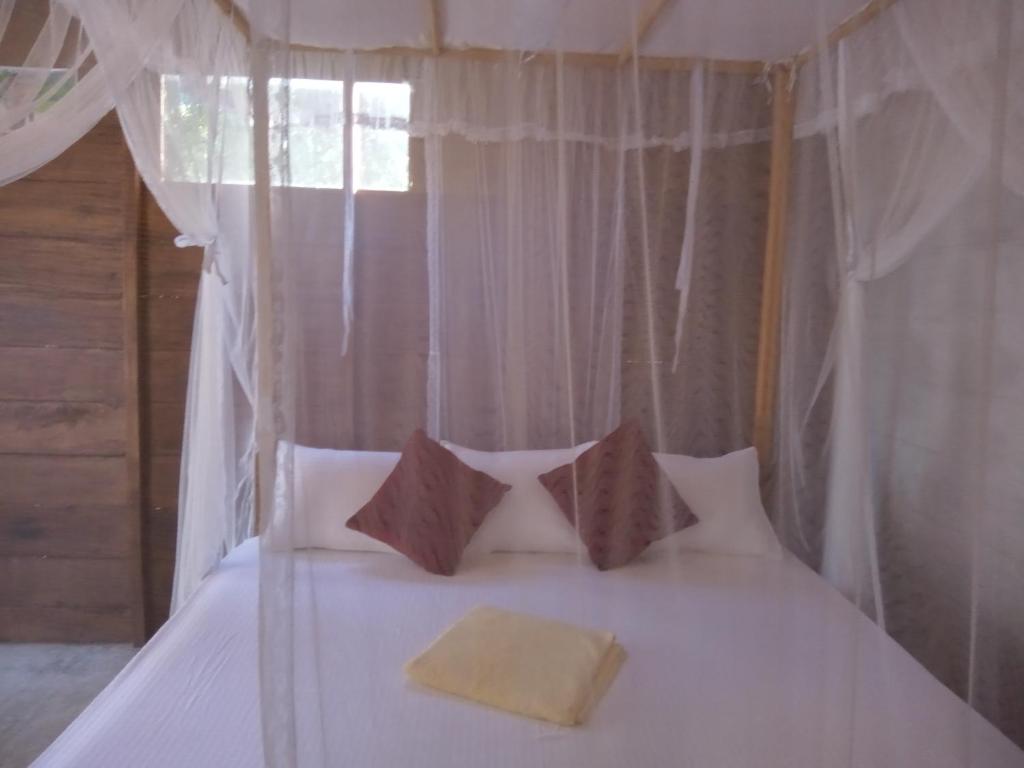 Кровать или кровати в номере Coconut Island Yala