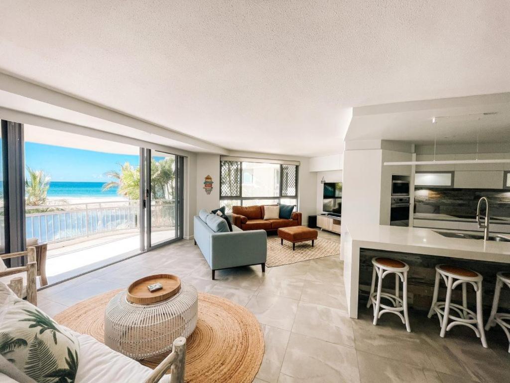 a living room with a view of the ocean at Oceanside Resort - Absolute Beachfront Apartments in Gold Coast