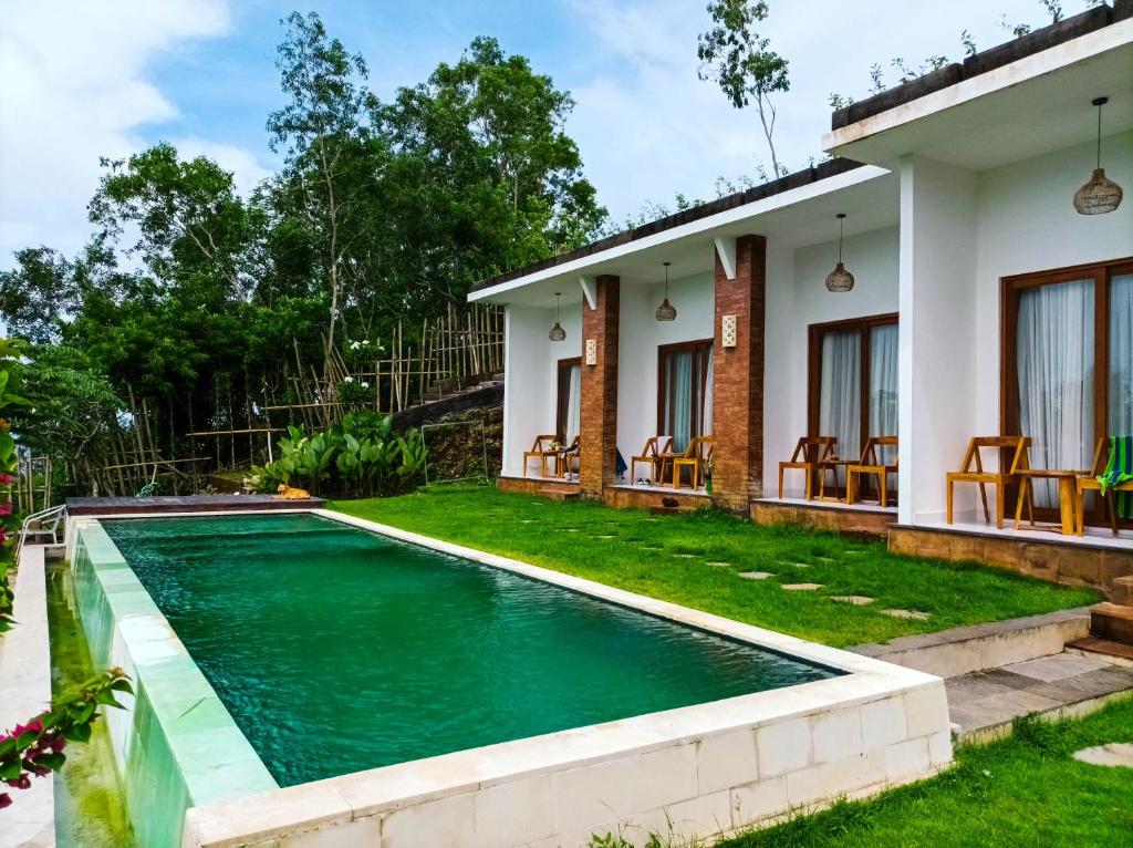 a swimming pool in the backyard of a house at Ancala Uluwatu in Uluwatu