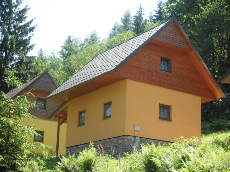 une maison avec un toit en gambrel au-dessus dans l'établissement Chaty pod Knížecí, Trojanovice, à Trojanovice