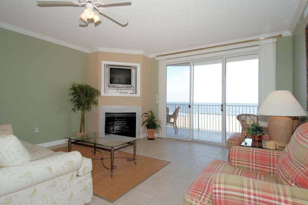 a living room with a couch and a fireplace at Ocean's Edge 302 in Ocean City