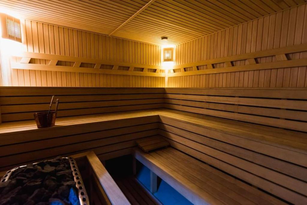 a large wooden sauna with a bench in it at Koncha-Zaspa Spa Hotel in Svalyava