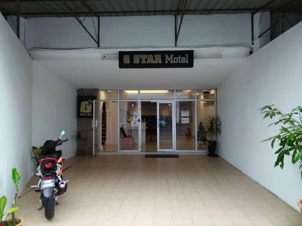 a motorcycle parked in front of a building at G Star Motel in Kuching