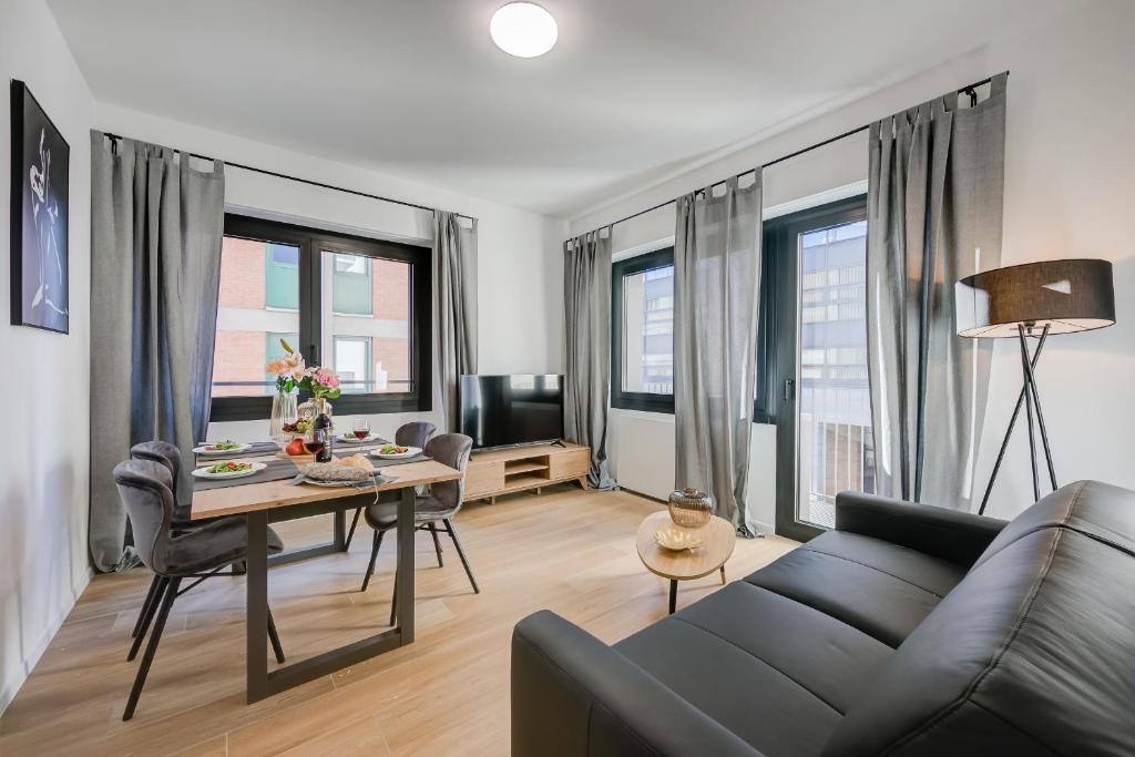 a living room with a couch and a table at Boutique Apartments - Happy Rentals in Lugano