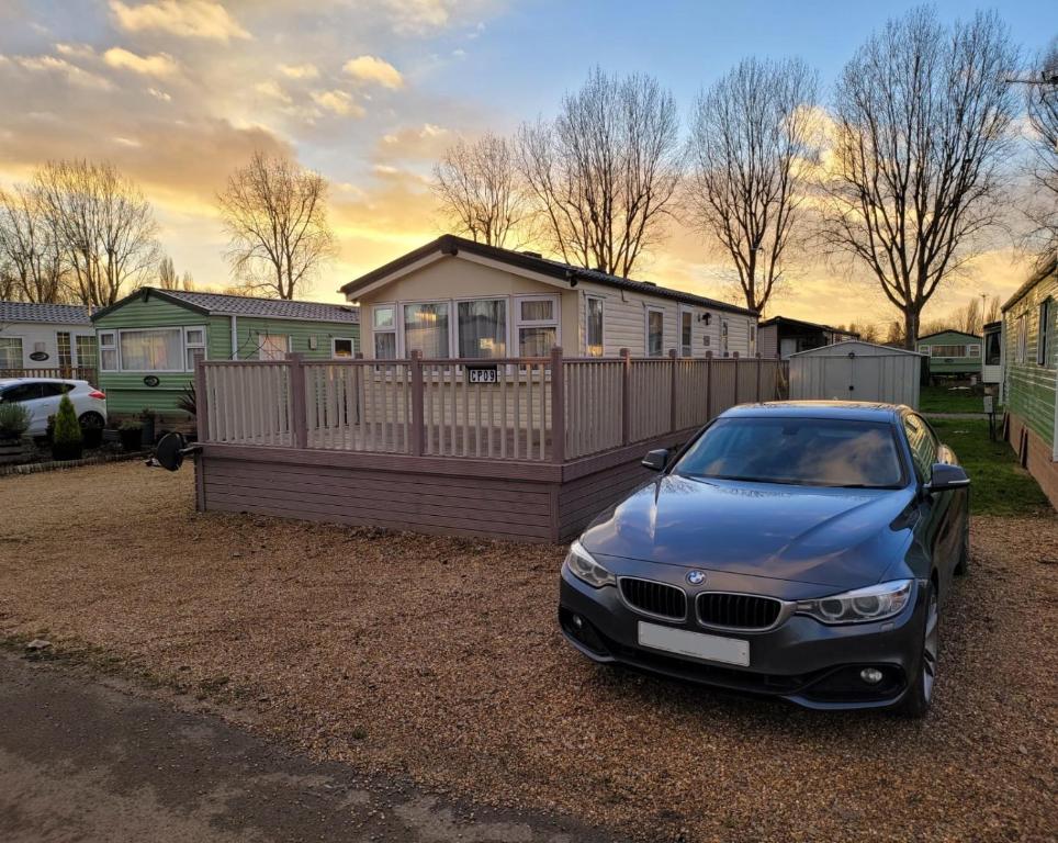 a car parked in front of a house at Lovely Static Caravan at Billing Aquadrome in Great Billing