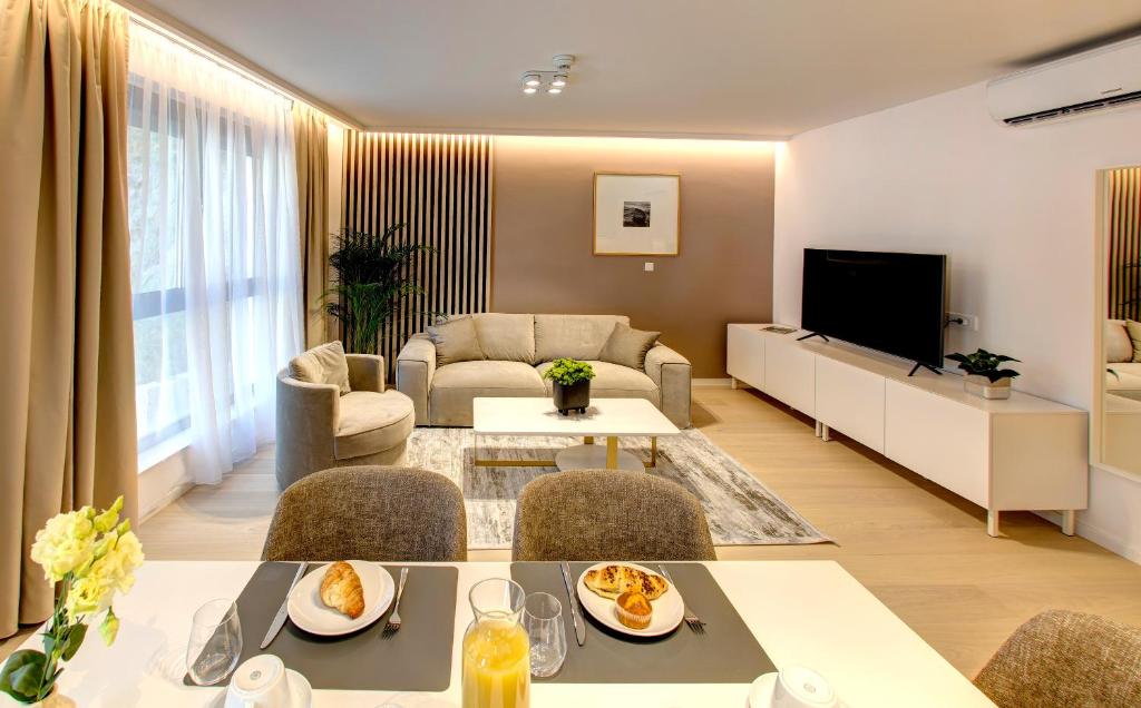 a living room with a couch and a table at Four Blue Seasons - Luxury Apartments Dubrovnik in Dubrovnik