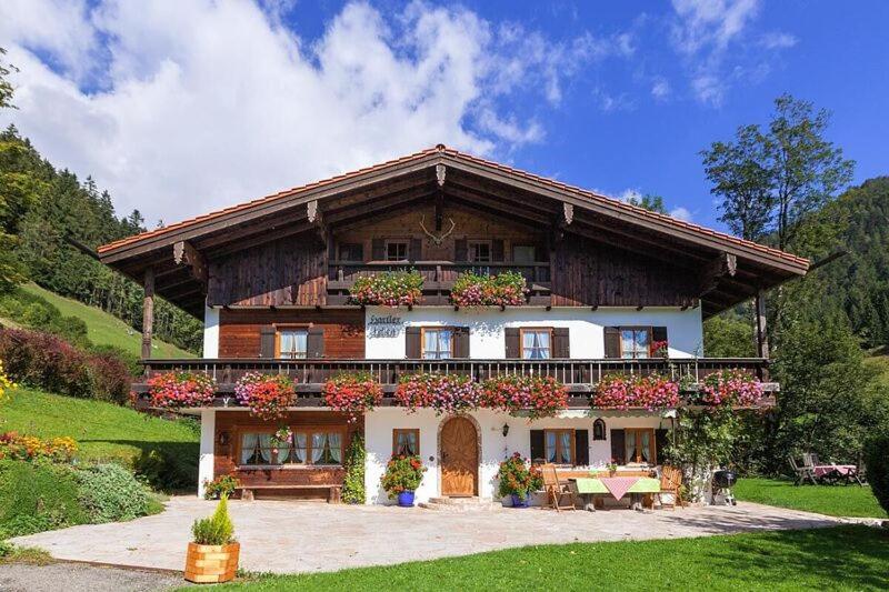a large house with flowers on the front of it at Hartlerlehen Rasp in Berchtesgaden