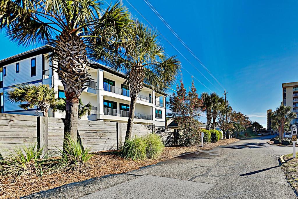a building with palm trees in front of a street at Mainsail IV in Destin