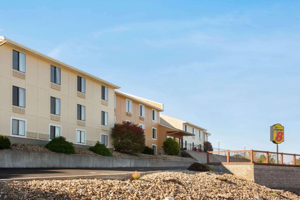 a hotel building with a sign on the side of a road at Super 8 by Wyndham Hannibal in Hannibal