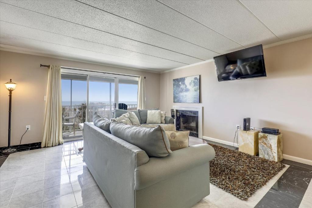 a living room with a couch and a fireplace at Ocean One in Ocean City