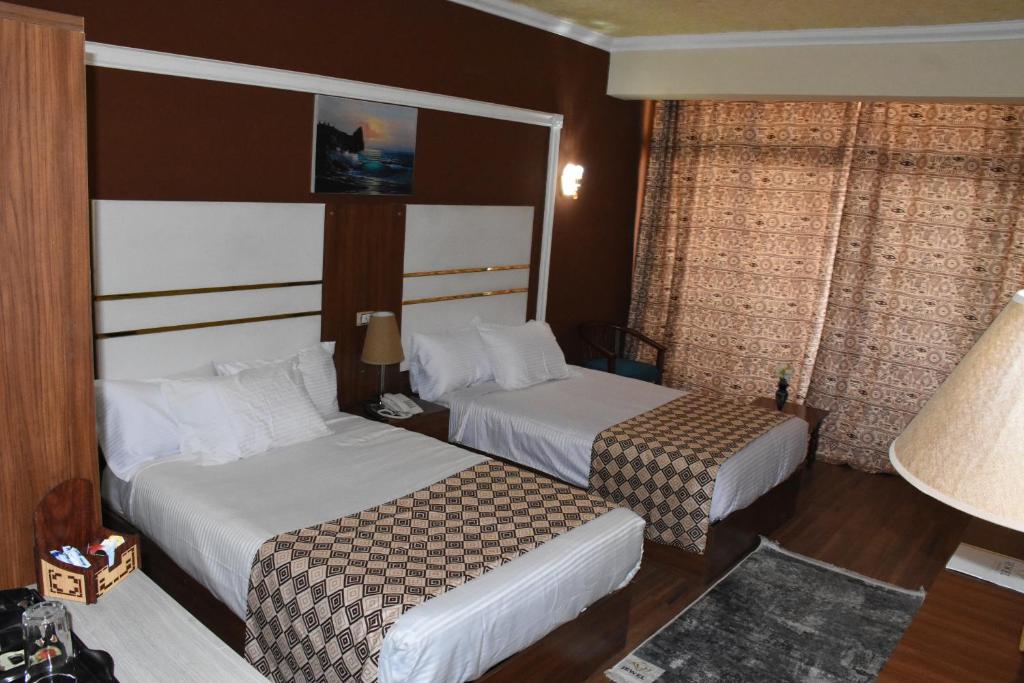 Postel nebo postele na pokoji v ubytování Jewel Luxor Hotel