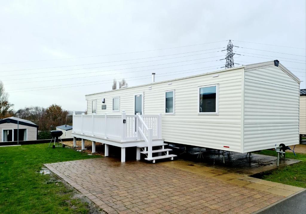 a white tiny house sitting on a trailer at Escape City Caravan in Lytchett Minster