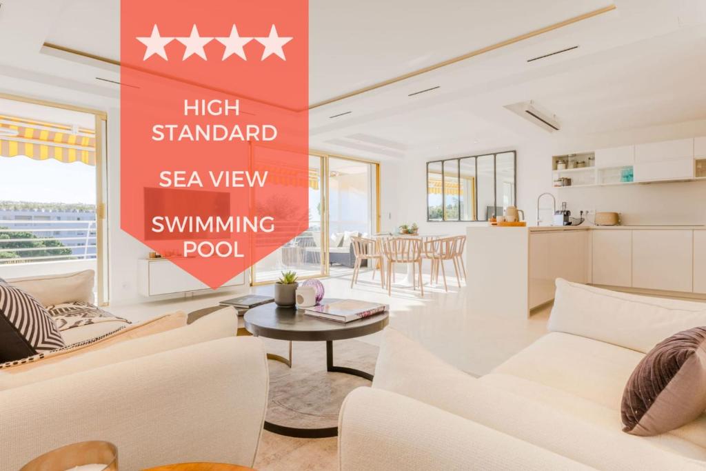 - un salon doté d'un mobilier blanc et d'un panneau rouge dans l'établissement 4-Room Apartment of 96m with a Stunning View, à Cannes