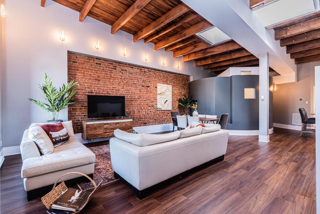 a living room with a couch and a fireplace at Family Friendly 3-bedroom beauty in Le Plateau by DenStays in Montréal