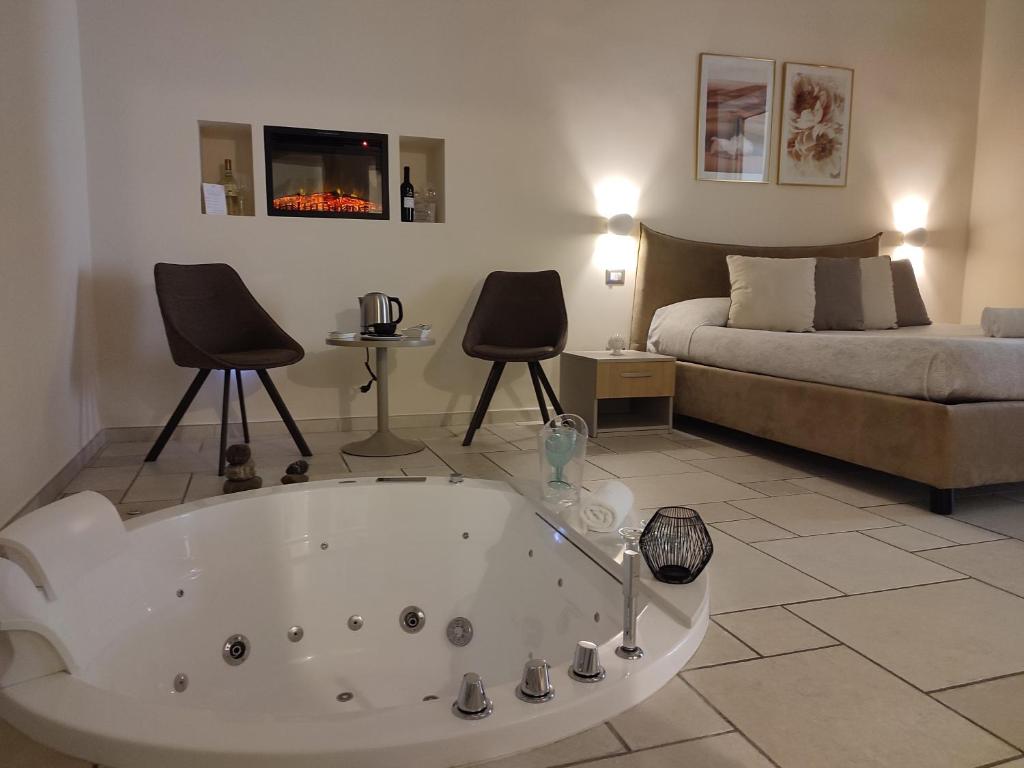 a living room with a bath tub and a bed at Lux Suite in Taranto