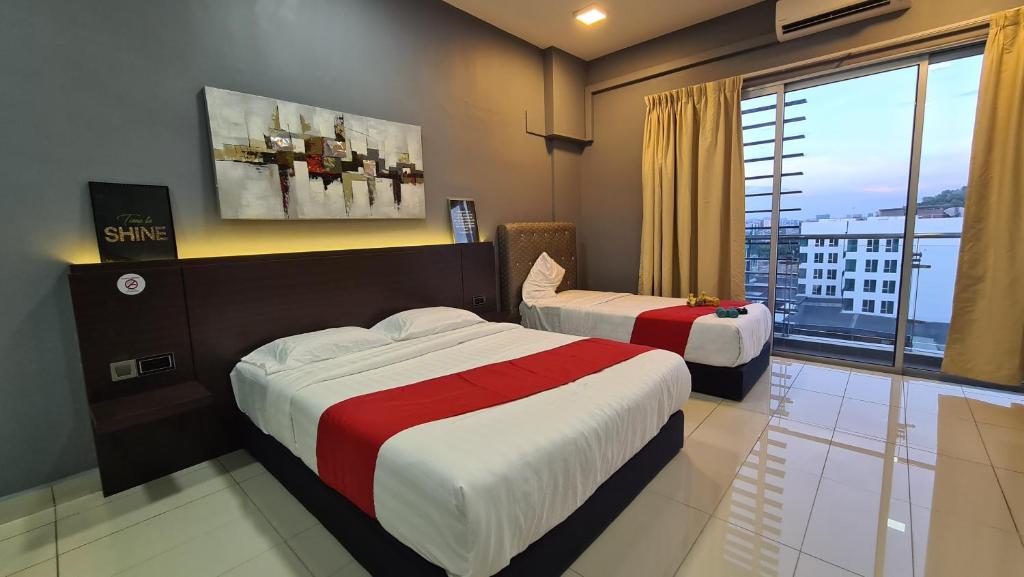 a hotel room with two beds and a large window at Aeropod KK Studio Unit 09 Near Airport And City Free Parking in Kota Kinabalu