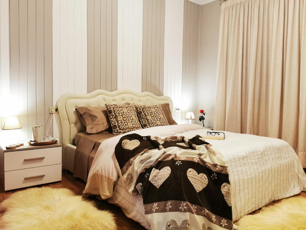 1 dormitorio con cama grande, mesita de noche y cama sidx sidx sidx sidx en Stella delle Grigne en Pasturo