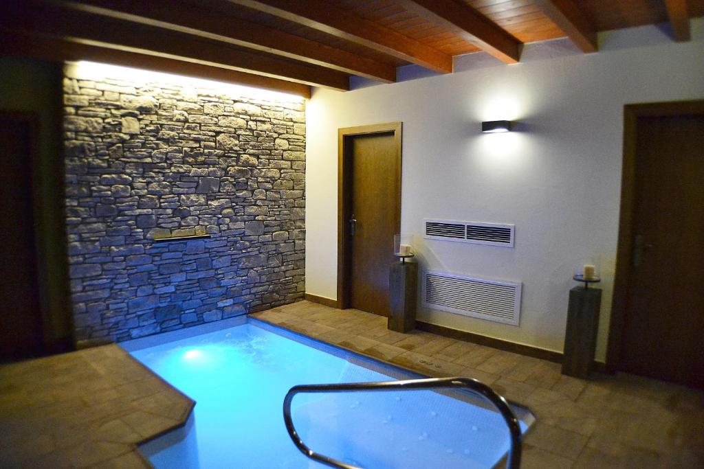 a swimming pool with a chair in a room at Alba D'Esteve. Casa Rural in Espot