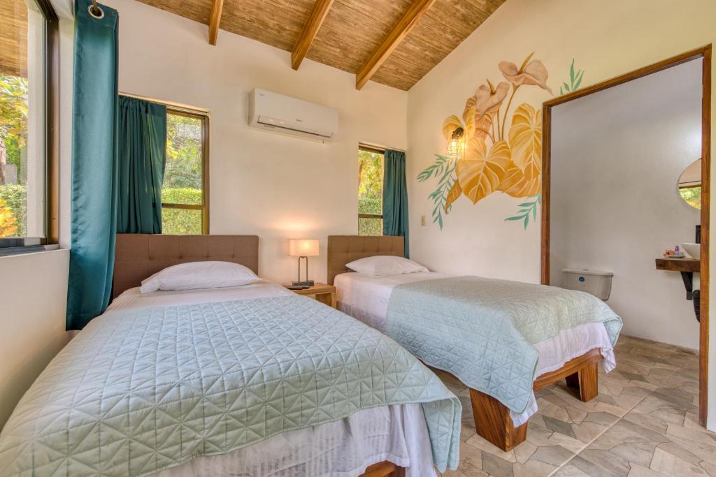 Postel nebo postele na pokoji v ubytování Hotel Villas Tangerine