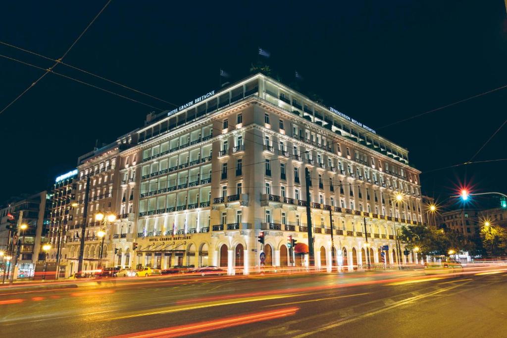 a large building on a city street at night at Hotel Grande Bretagne, a Luxury Collection Hotel, Athens in Athens