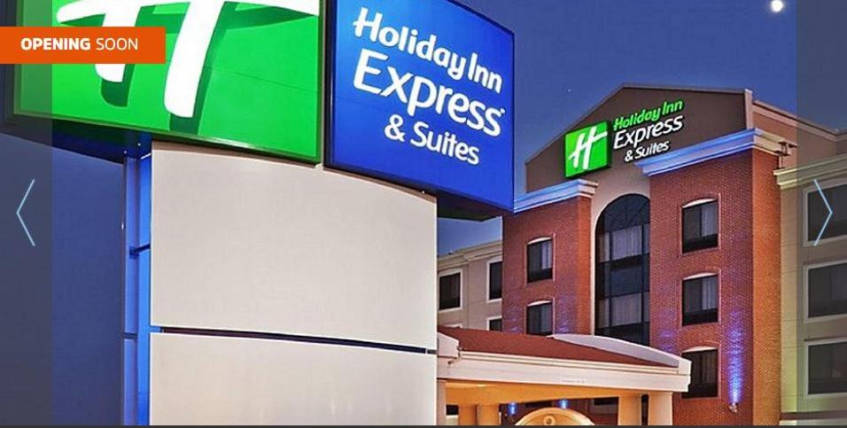 un cartel expreso y suites de una posada de Houston frente a un edificio en Holiday Inn Express & Suites Milwaukee NW - Park Place, an IHG Hotel, en Milwaukee