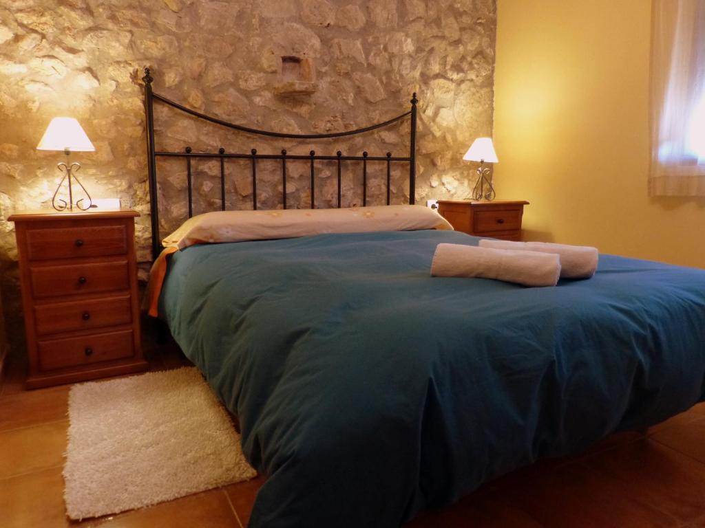 1 dormitorio con 1 cama con 2 toallas en La Caseta Del Forn (Penyagolosa), en Vistabella del Maestrazgo