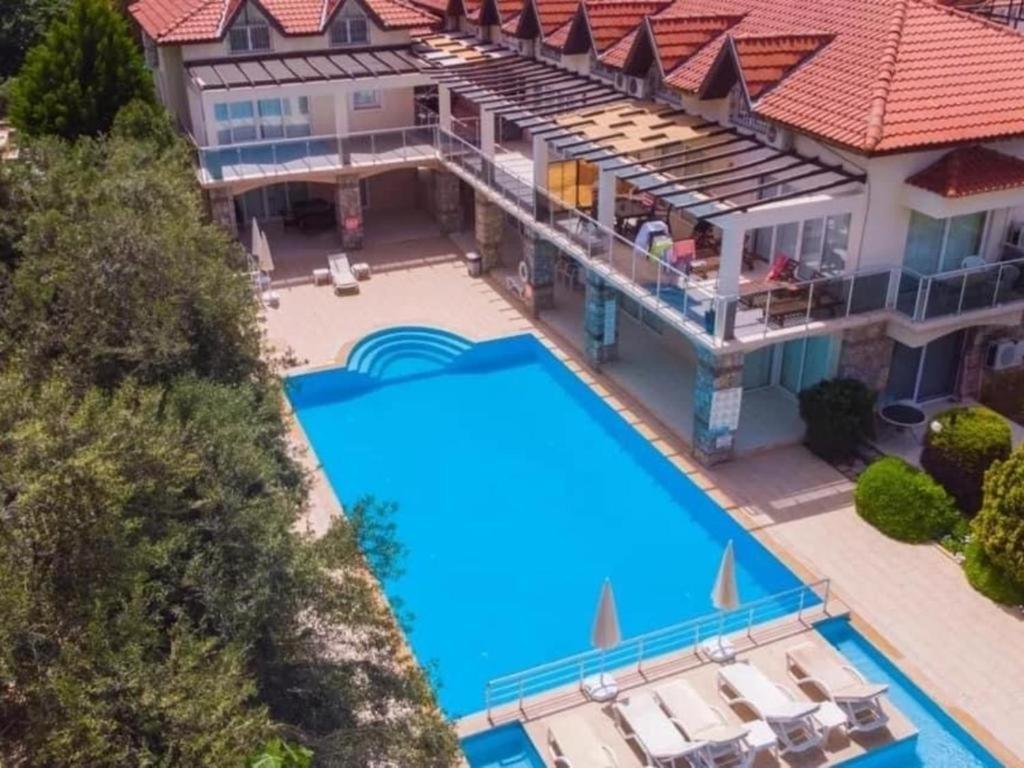 an aerial view of a house with a swimming pool at Olivia Apartment at Ölüdeniz - Central in Oludeniz