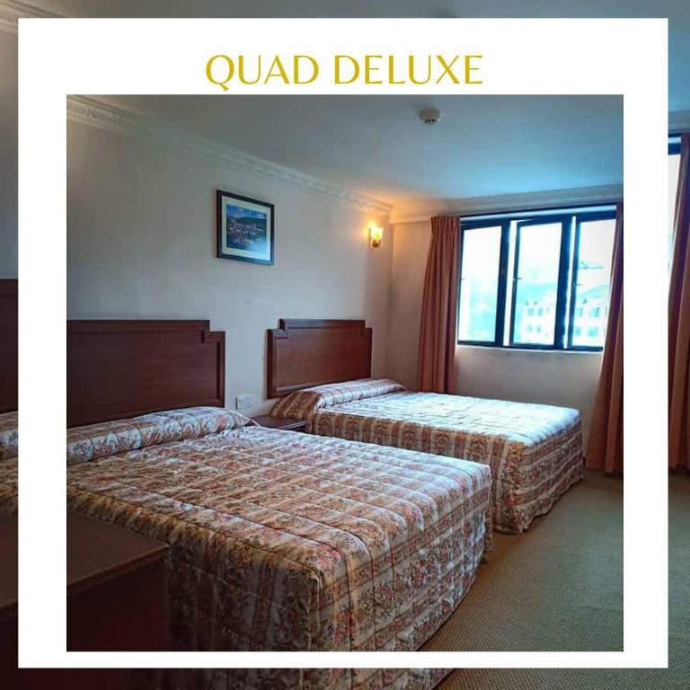 Postel nebo postele na pokoji v ubytování Jasmine Hotel