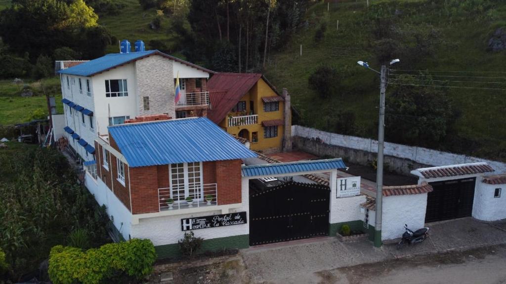 an overhead view of a house with a blue roof at Portal de la Cascada - Mongui in Monguí