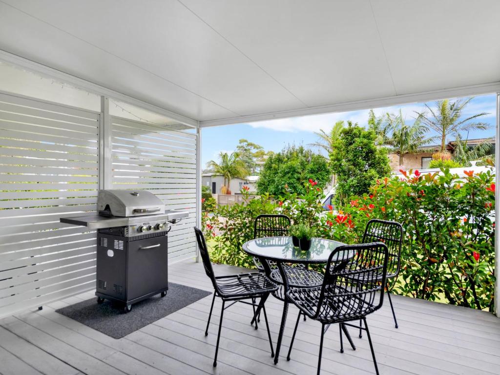 a patio with a table and chairs and a grill at Thurlow Avenue 49 Unit 1 in Nelson Bay