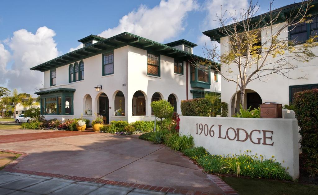 a large white house with a bus lodge sign in front of it at 1906 Lodge in San Diego